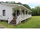 Charming front porch with wooden stairs and white railing at 124 Wynn Rd, Mcdonough, GA 30252