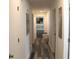 Hallway with wood-look floors leading to bedrooms with comfortable bedding and stylish decor at 124 Wynn Rd, Mcdonough, GA 30252