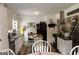 Spacious kitchen with white cabinetry, black appliances, and a cozy breakfast nook, perfect for Gathering meals at 124 Wynn Rd, Mcdonough, GA 30252