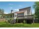 Back exterior view of the home with a spacious deck, sunroom and a well-maintained yard, perfect for relaxation and outdoor activities at 4117 Signal Sw Rdg, Lilburn, GA 30047