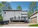 Two-story home with a grey back deck and a detached single car garage at 4117 Signal Sw Rdg, Lilburn, GA 30047