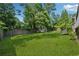 Large, grassy backyard with a storage shed and fenced perimeter at 4117 Signal Sw Rdg, Lilburn, GA 30047