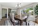 The dining room has a chandelier, a view to the yard, and hard wood floors at 4117 Signal Sw Rdg, Lilburn, GA 30047