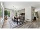 Dining room features a chandelier, large window with natural light, and wood floors at 4117 Signal Sw Rdg, Lilburn, GA 30047