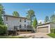 Exterior view of the house featuring a deck, attached garage, and a paved driveway at 4117 Signal Sw Rdg, Lilburn, GA 30047