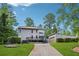 Exterior view with a driveway, detached garage, and a well-kept lawn at 4117 Signal Sw Rdg, Lilburn, GA 30047