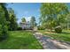 Exterior view featuring a long driveway, grassy lawn, and garage at 4117 Signal Sw Rdg, Lilburn, GA 30047