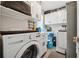 Functional laundry area with washer, dryer, overhead storage, and ample counter space at 4117 Signal Sw Rdg, Lilburn, GA 30047