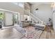 Spacious living room features a large sofa, high ceilings, and wood floors at 4117 Signal Sw Rdg, Lilburn, GA 30047