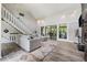 Bright living room with high ceilings, wood floors, and large glass sliding doors at 4117 Signal Sw Rdg, Lilburn, GA 30047
