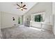 Spacious main bedroom with neutral tones, vaulted ceiling, ceiling fan, a dresser, and carpeted floors at 4117 Signal Sw Rdg, Lilburn, GA 30047