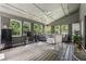 Cozy sunroom with vaulted ceilings, a ceiling fan, hardwood floors, and an abundance of natural light at 4117 Signal Sw Rdg, Lilburn, GA 30047