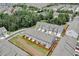 Aerial view of townhomes featuring landscaped backyards with privacy fences at 7682 Baron Rd, Fairburn, GA 30213
