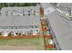 Aerial view of townhomes with fenced backyards and small patios at 7682 Baron Rd, Fairburn, GA 30213