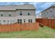 Fenced backyard features a lush grass lawn and a wood privacy fence at 7682 Baron Rd, Fairburn, GA 30213