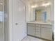 Bathroom featuring double sinks, quartz countertops, and a glass enclosed shower at 7682 Baron Rd, Fairburn, GA 30213