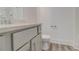 Modern bathroom with gray cabinets, updated hardware, wood-look flooring, and a chrome faucet at 7682 Baron Rd, Fairburn, GA 30213