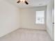 This bedroom features a window for natural light and a ceiling fan for air circulation at 7682 Baron Rd, Fairburn, GA 30213