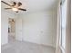 This bedroom boasts plush carpet, white walls, a ceiling fan, and a window with curtain accents at 7682 Baron Rd, Fairburn, GA 30213