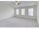 Spacious bedroom with lots of natural light, carpet flooring, and a ceiling fan at 7682 Baron Rd, Fairburn, GA 30213