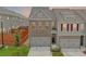 Charming two-story townhome with brick and siding accents and an attached garage at 7682 Baron Rd, Fairburn, GA 30213
