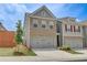 Charming two-story brick home featuring an attached two-car garage and manicured lawn at 7682 Baron Rd, Fairburn, GA 30213