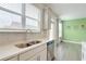 Bright kitchen with white cabinets, stainless steel sink, and natural light at 7682 Baron Rd, Fairburn, GA 30213