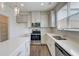 Bright kitchen with white cabinets, stainless steel appliances, and center island at 7682 Baron Rd, Fairburn, GA 30213