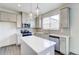 Modern kitchen with an island, pendant lights, stainless steel appliances, and bright countertops at 7682 Baron Rd, Fairburn, GA 30213