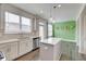 Well-lit kitchen with stainless steel appliances, an island, and an adjacent dining area at 7682 Baron Rd, Fairburn, GA 30213