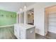 Well-lit kitchen featuring an island, pendant lights, wood floors, and walk-in pantry at 7682 Baron Rd, Fairburn, GA 30213