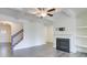 Spacious living room featuring coffered ceilings, fireplace, and staircase access at 7682 Baron Rd, Fairburn, GA 30213