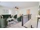 Staged open loft area with carpet flooring, ceiling fan, and stylish green furniture at 7682 Baron Rd, Fairburn, GA 30213