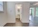 Bright half-bath with pedestal sink and modern finishes near the entry at 7682 Baron Rd, Fairburn, GA 30213