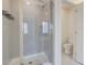 The shower has a glass enclosure, rain shower head, and tiled walls with a recessed niche at 7682 Baron Rd, Fairburn, GA 30213