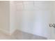 This walk-in closet provides generous storage with ample shelving and a light at 7682 Baron Rd, Fairburn, GA 30213