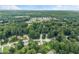 An aerial view of the neighborhood, showcasing beautiful landscaping with homes nestled among the trees at 1083 Wash Lee Sw Dr, Lilburn, GA 30047