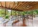 Relax on this screened-in porch with ceiling fans, overlooking the tranquil backyard at 1083 Wash Lee Sw Dr, Lilburn, GA 30047
