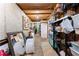 Unfinished basement storage area with shelving and concrete floor at 1083 Wash Lee Sw Dr, Lilburn, GA 30047