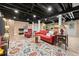 Basement featuring exposed ceiling, living area, TV, and colorful rug at 1083 Wash Lee Sw Dr, Lilburn, GA 30047
