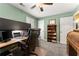 This bedroom features a wooden desk, ceiling fan, and light green walls at 1083 Wash Lee Sw Dr, Lilburn, GA 30047