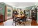 Light-filled dining room featuring a classic table, chairs, and hardwood floors at 1083 Wash Lee Sw Dr, Lilburn, GA 30047