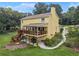 Backyard with a screened-in porch, a deck with stairs to the yard, a well-maintained yard, and a partially covered patio at 1083 Wash Lee Sw Dr, Lilburn, GA 30047