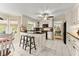 Bright kitchen features white cabinets, granite counters, modern appliances, breakfast bar seating, and tile floors at 1083 Wash Lee Sw Dr, Lilburn, GA 30047