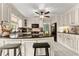 Spacious kitchen featuring an island with barstools, granite counters, stainless appliances and white cabinetry at 1083 Wash Lee Sw Dr, Lilburn, GA 30047