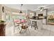 Charming eat-in kitchen featuring an island with seating, granite counters, and lots of natural light at 1083 Wash Lee Sw Dr, Lilburn, GA 30047