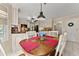 Eat-in kitchen with white cabinets, granite counters, red accents, and stainless appliances overlooking the backyard at 1083 Wash Lee Sw Dr, Lilburn, GA 30047