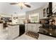 Bright eat-in kitchen with granite counters, white cabinetry, island and modern appliances with tile flooring at 1083 Wash Lee Sw Dr, Lilburn, GA 30047