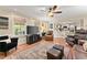 Well-lit living room with hardwood floors and direct access to the kitchen at 1083 Wash Lee Sw Dr, Lilburn, GA 30047
