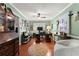 Cozy home office with wood floors, built-in shelves, and a ceiling fan at 1083 Wash Lee Sw Dr, Lilburn, GA 30047